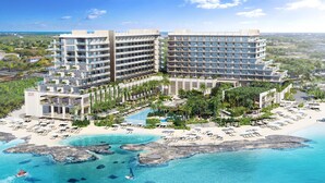 Un hotel grande con varios pisos, piscina y zona de playa.