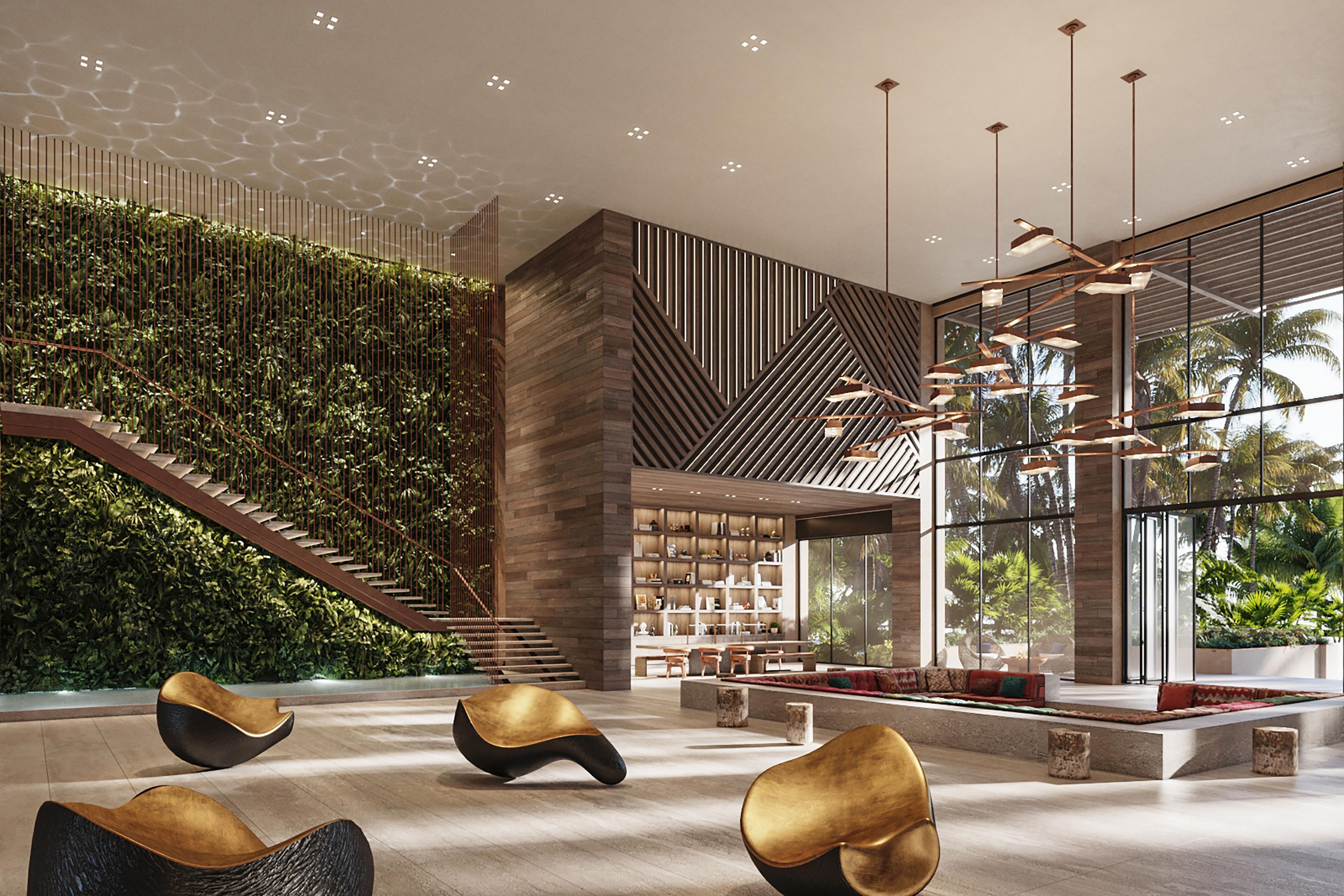 A modern interior with a staircase, seating area, and a wall with vertical greenery.