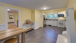 A modern kitchen with white cabinets, a stainless steel refrigerator, and a microwave. - Walk to Sorrento Town Dock: Pet-Friendly Apartment (Sorrento)