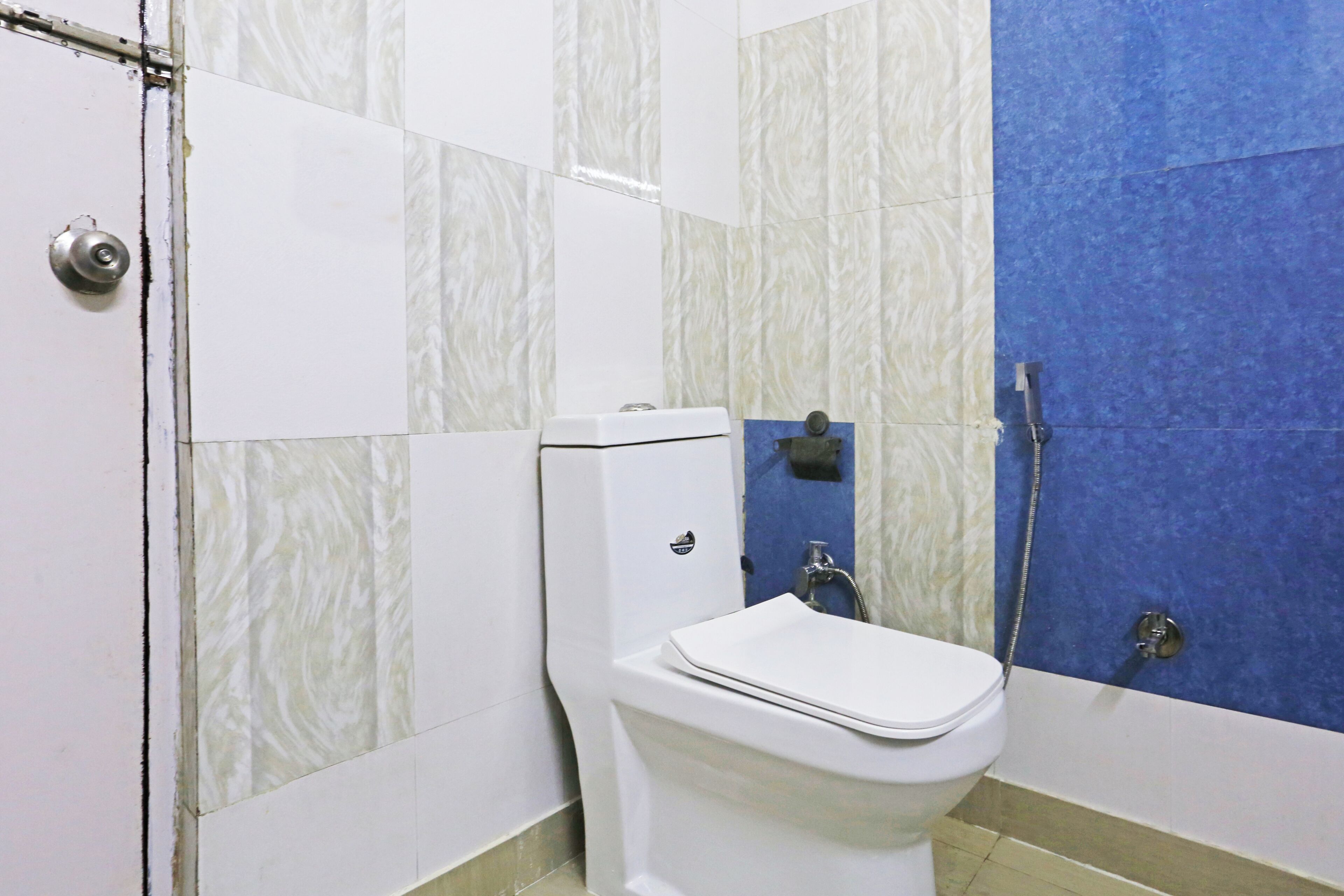 A bathroom with a toilet, a shower, and a sink.