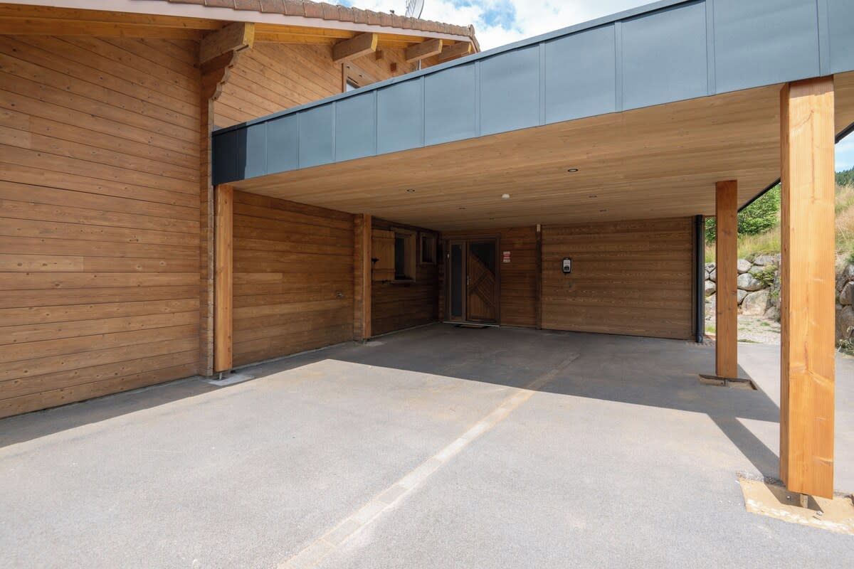 A building with a covered entrance and a concrete floor.