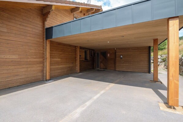 A building with a covered entrance and a concrete floor.