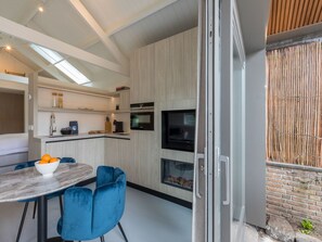 Enjoy cooking in this kitchen with appliances, a central island, and a large window.