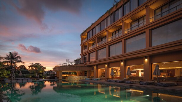 A modern hotel with a large pool, multiple balconies, and outdoor seating areas. - Noema Resort Pererenan Bali (Pererenan)
