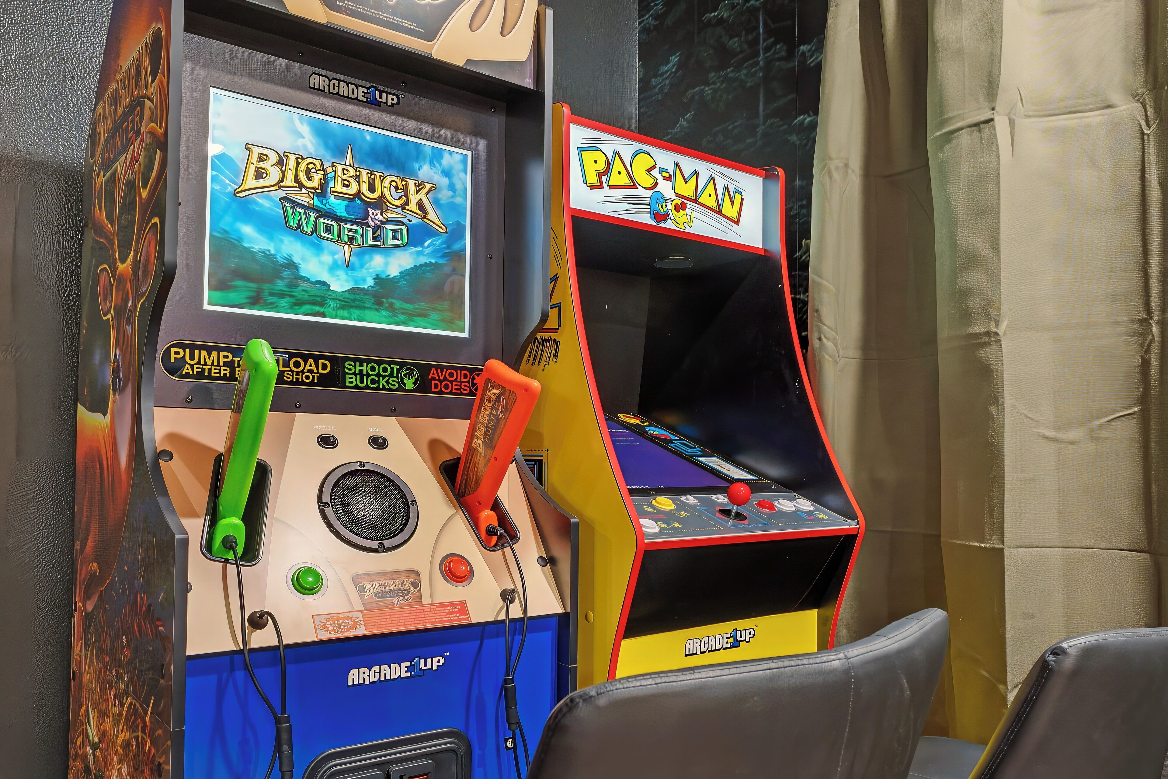 Two arcade machines, one for Big Buck World and one for Pac-Man, with visible controls and instructions.