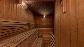 A sauna with wooden benches and a sloped ceiling.