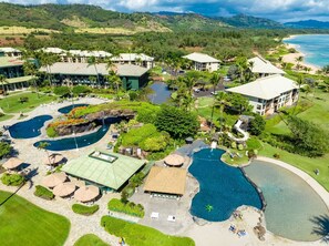A resort with multiple swimming pools, a golf course, and a beach area. - Watch Pacific Ocean sunrise from the comfort of your private ocean view lanai! (Lihue)