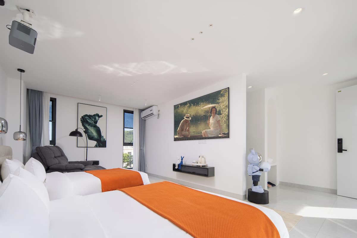 A modern hotel room with two beds, a large window, a painting, and a robot statue.