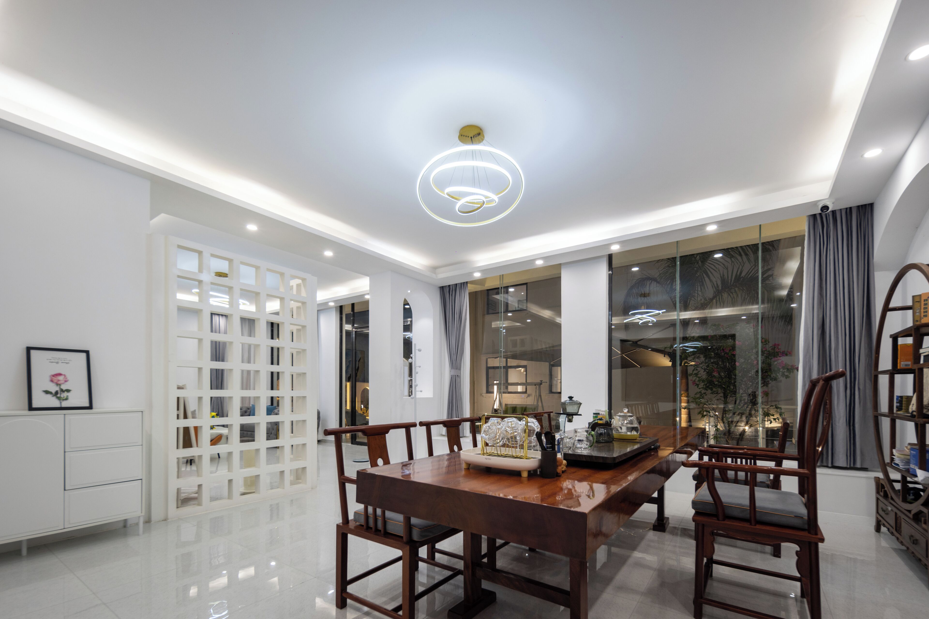 A dining area with a wooden table, chairs, and a decorative centerpiece.