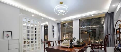 A dining area with a wooden table, chairs, and a decorative centerpiece.