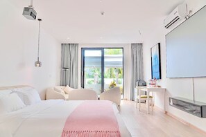 A modern bedroom with a large bed, a desk, and a TV. - Dragging Water to Lead Mountain (Sanya)