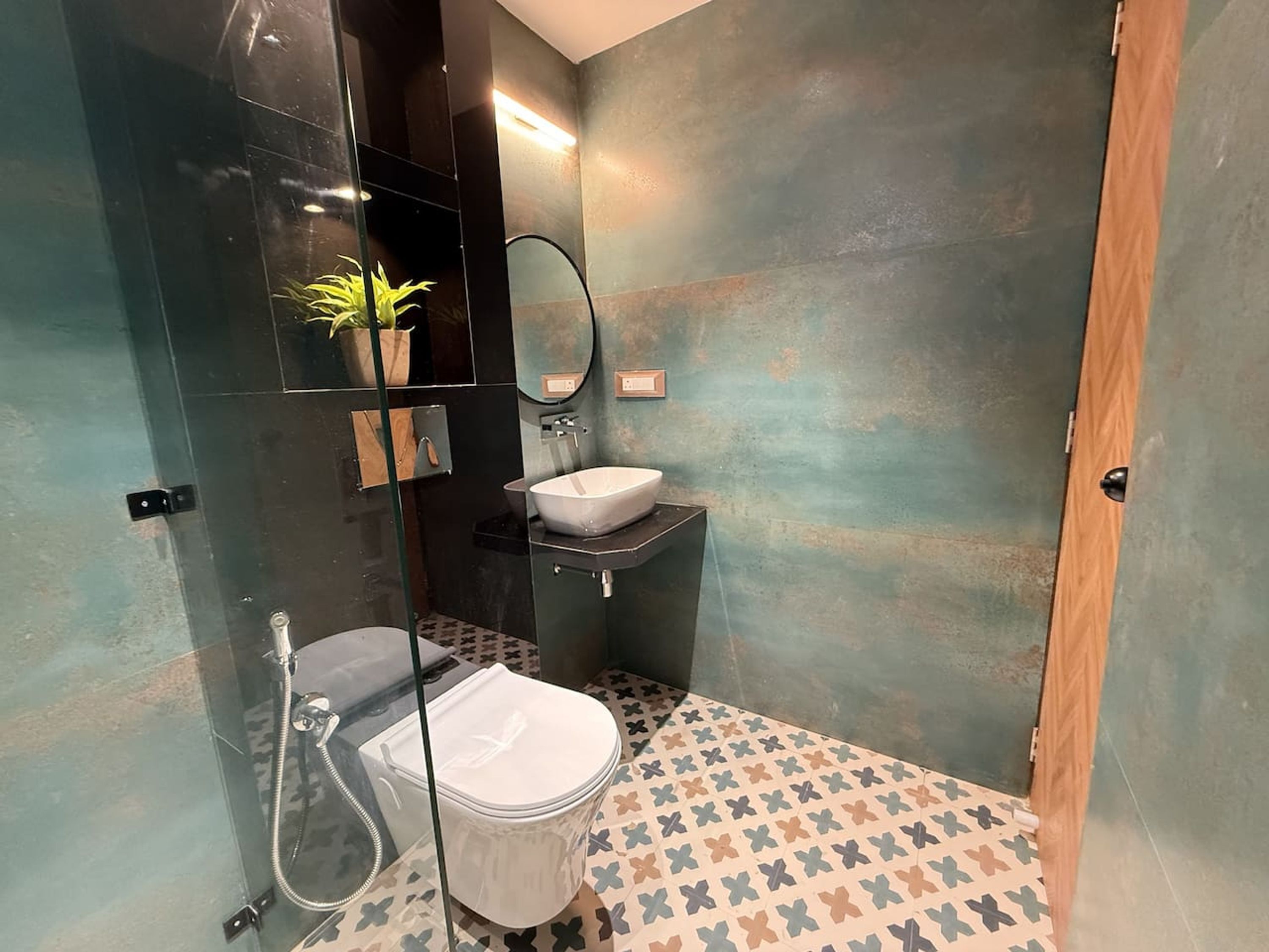 A small bathroom with a toilet, sink, and shower.