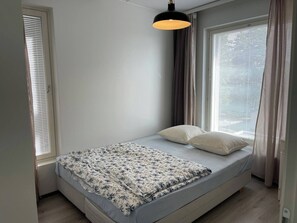 A small, single-bed room with a window on one side and a door on the other. - Room-cozy 3 Bedroom Apartment in Heart o (Espoo)