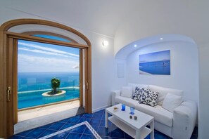 Departamento Deluxe, alberca privada, vista al mar | Área de sala de estar
