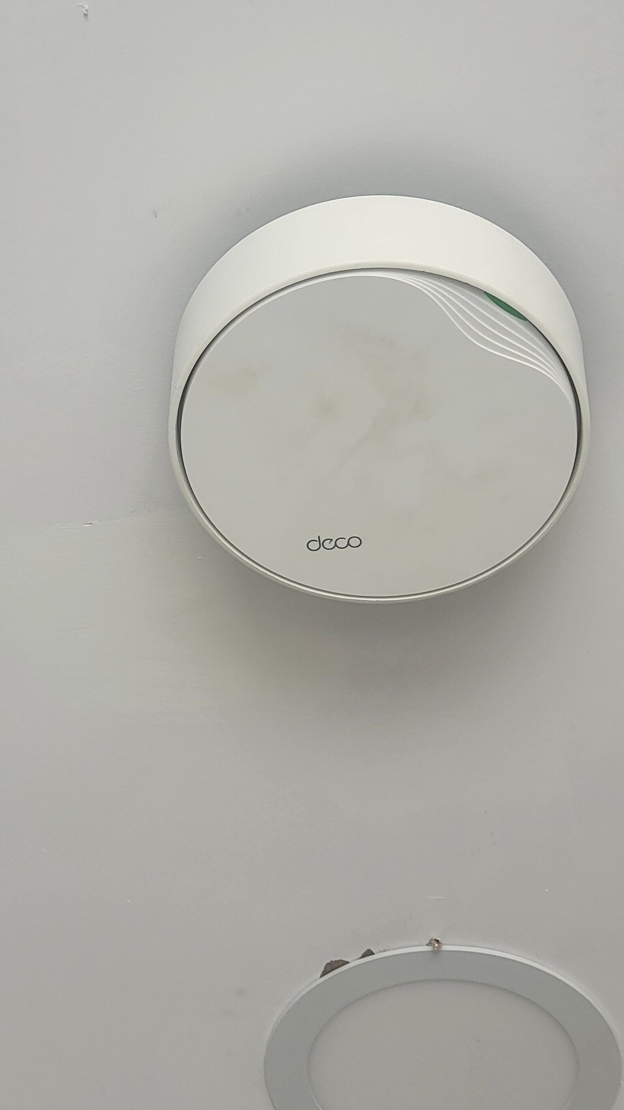 A circular object with the word "deco" on it, mounted on a wall.