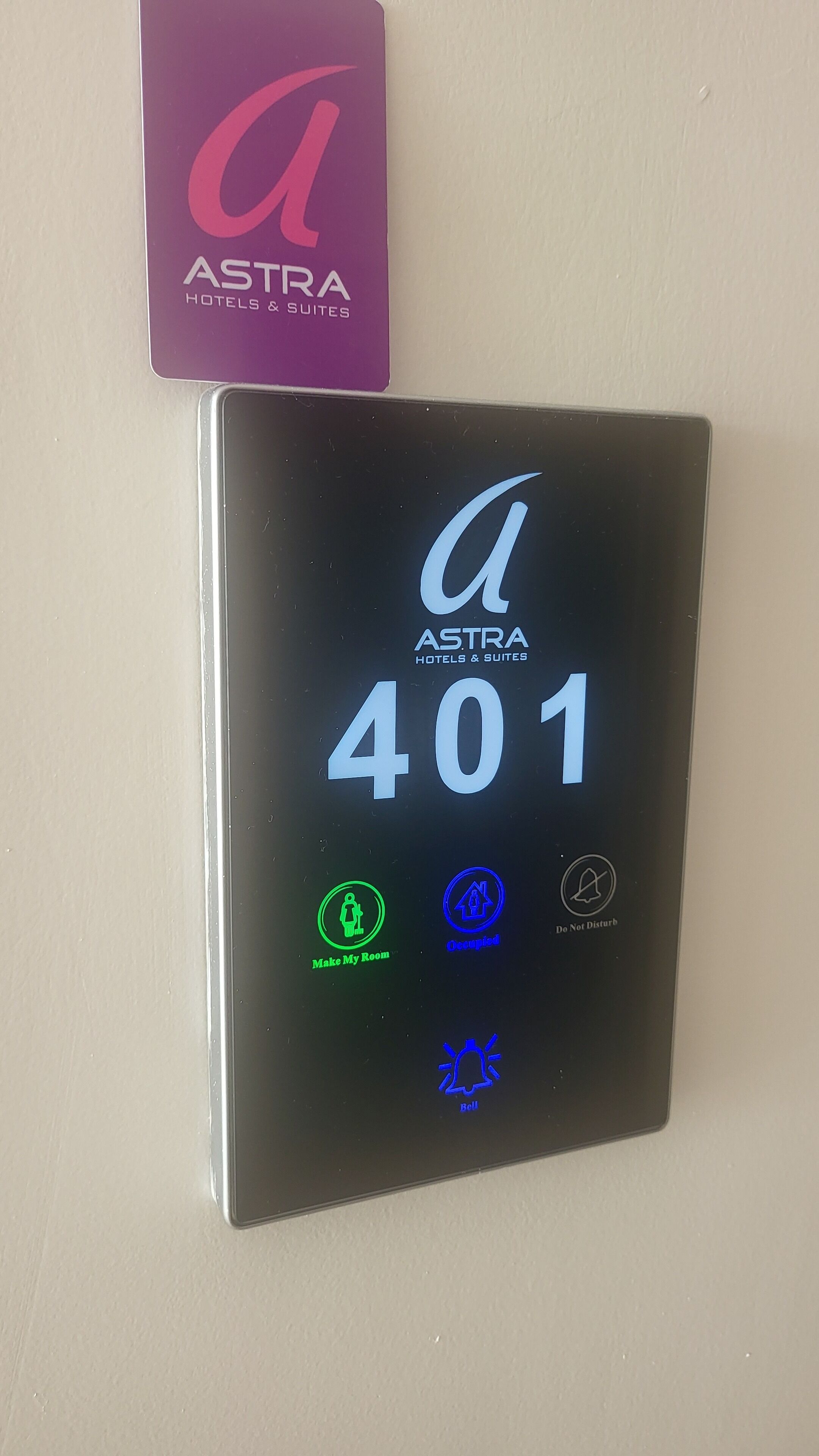 A digital key card for Astra Hotels & Suites with room number 401, featuring icons for room service, housekeeping, and a do not disturb symbol.