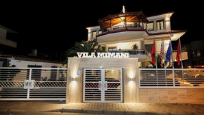 A hotel entrance with a sign reading "VILA MIMANI" and a gated driveway. - Hotel Mimani (Berat)