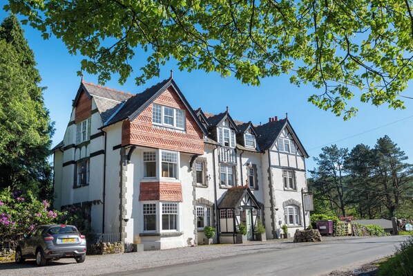 A large, multi-story building with a traditional architectural style, featuring multiple windows and a prominent entrance. - Stanley House (Holmrook)