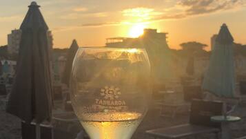 Ein Glas Wasser mit Sonnenuntergang im Hintergrund.