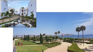 A resort with a pool, manicured gardens, and a view of the sea. - Cozy Beachside Haven (Pulpi)