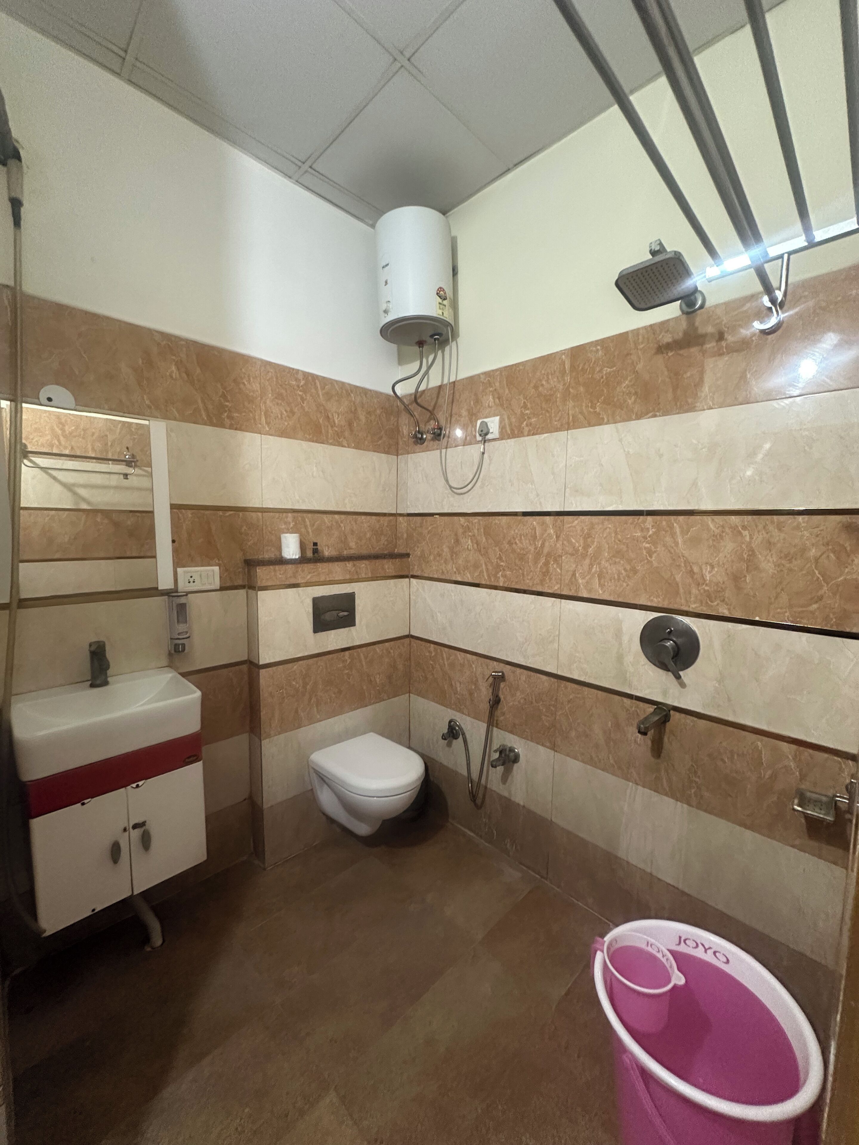 A bathroom with a toilet, sink, and shower.