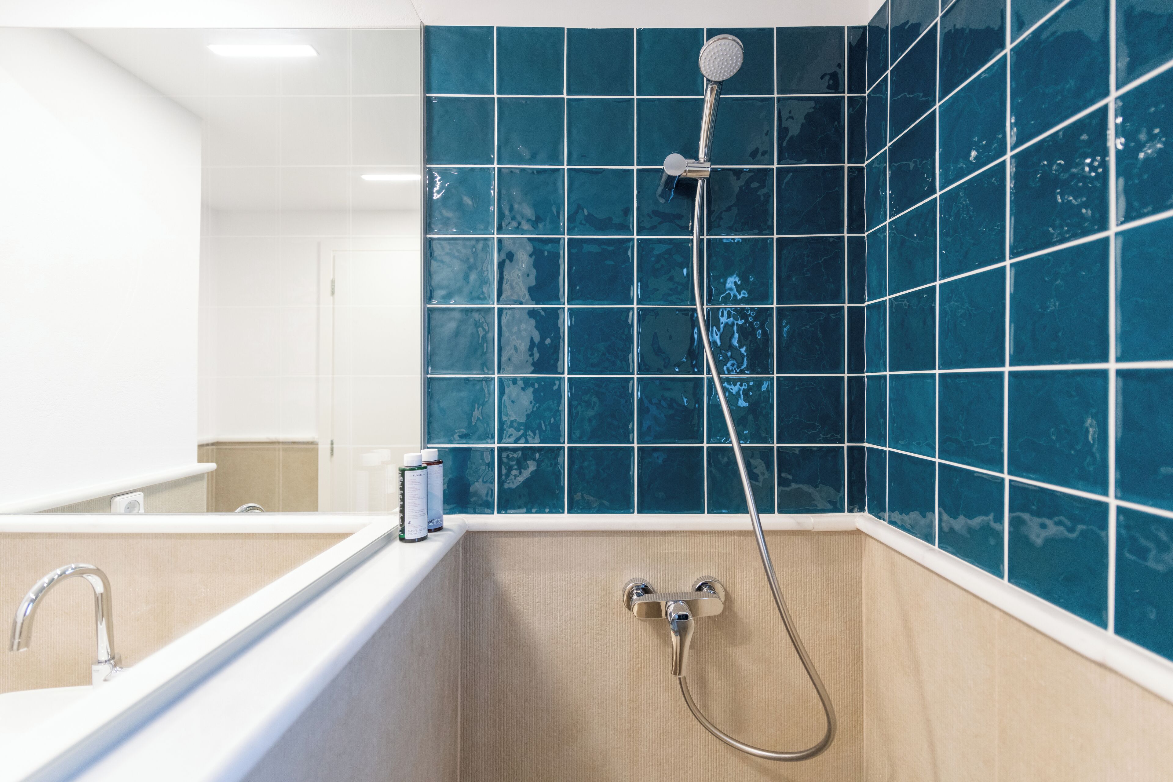A bathroom with a bathtub, a shower, and a sink.