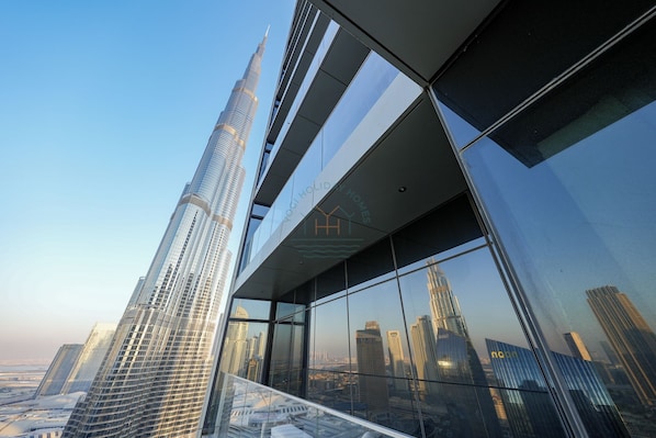 A high-rise building with a modern glass facade and a prominent spire.