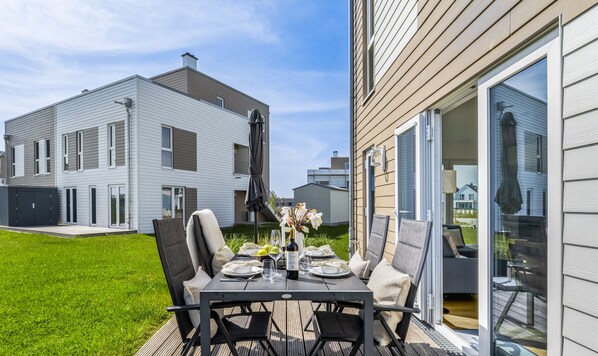 Enjoy a dining experience on the deck with a beautifully set table for two.