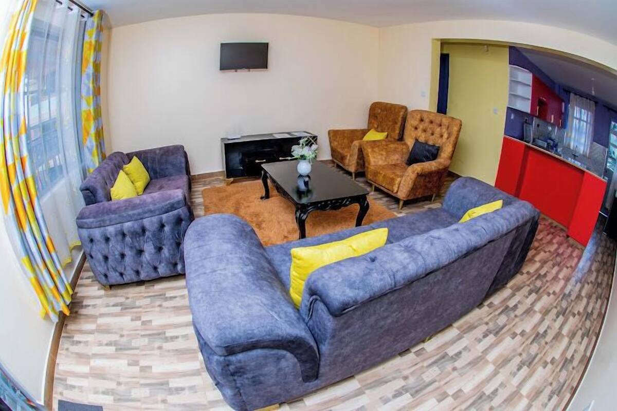 A living room with two sofas, a coffee table, and a TV.