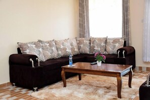Executive Apartment, Balcony, Mountain View | Living area | 43-inch TV with cable channels - A & B Cozy Apartments (Kitale)
