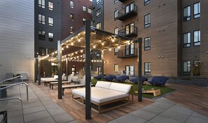 Relax under twinkling string lights in the courtyard, featuring cozy loungers, cornhole, and a serene ambiance perfect for unwinding. - Botanicals & Cattle Vibes | Two-Suite Vista Escape (Boise)