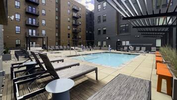 Relax by the pool surrounded by comfortable lounge chairs and tables.