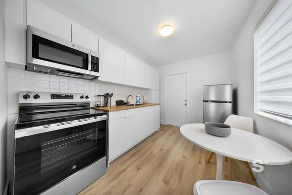 Fridge, microwave, stovetop, coffee/tea maker