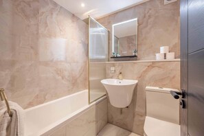 Shower, hair dryer, towels, shampoo