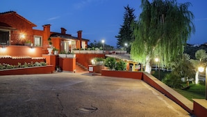 Una casa grande y luminosa con un amplio camino de entrada y un jardín ajardinado.