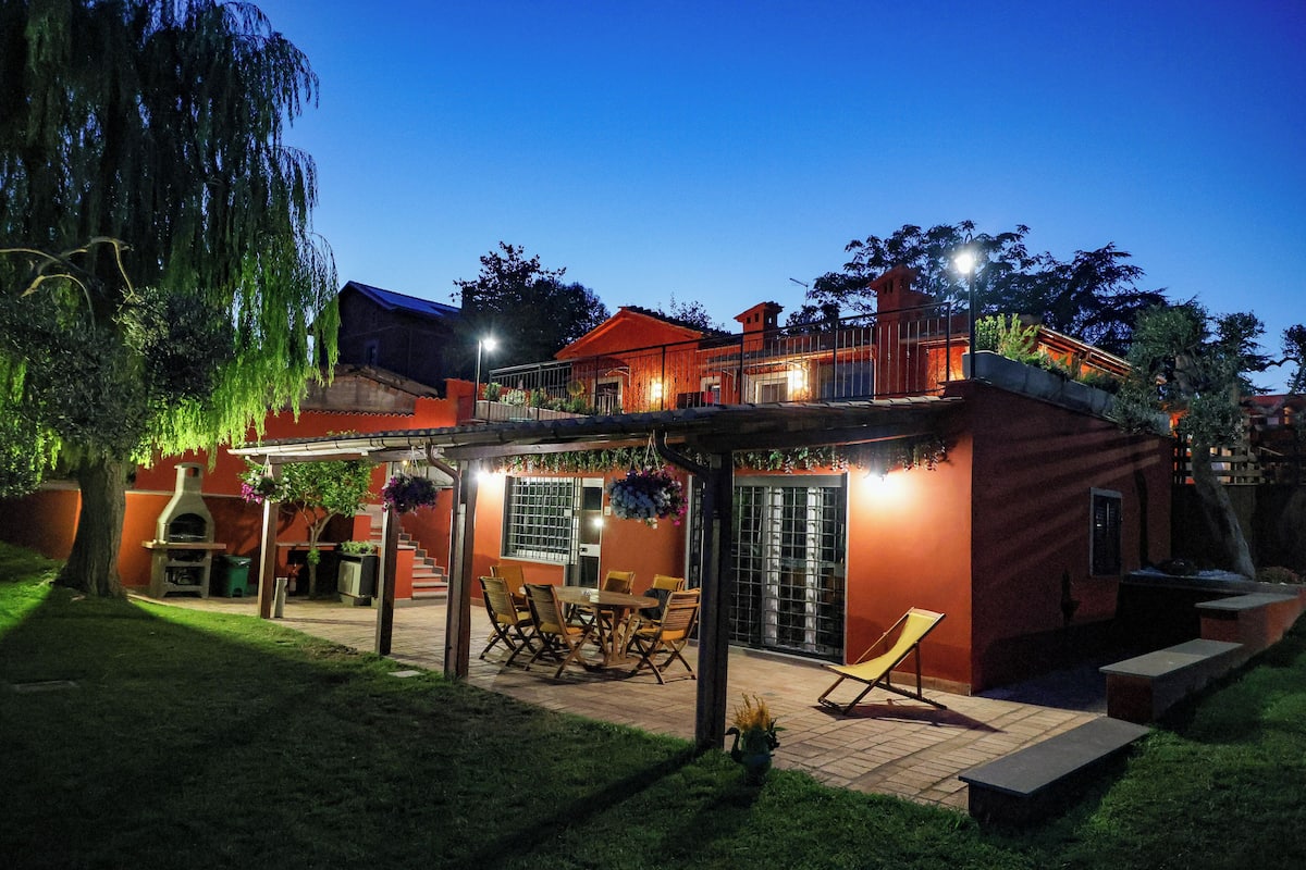 A house with a patio, outdoor seating, and a covered area.
