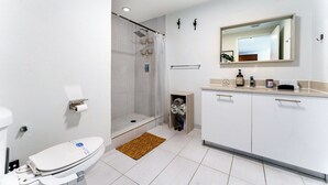 A modern bathroom with a toilet, shower, and sink. - 1BR Miami Retreat w/BBQ, Pool, & Skyline Views (Miami)