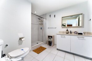 A modern bathroom with a toilet, shower, and sink. - 1BR Miami Retreat w/BBQ, Pool, & Skyline Views (Miami)