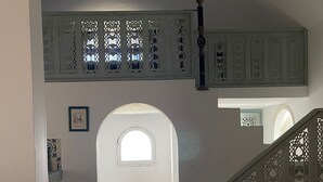A staircase with intricate wooden railings leading to an upper level. - Villa Dar Othman (cap zebib)
