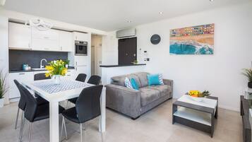 Standard Apartment | Living area | 55-inch flat-screen TV with satellite channels, TV