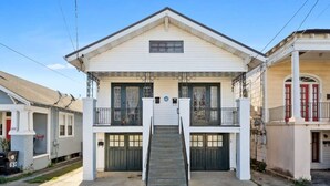 A two-story house with a central staircase, a front porch, and a garage.