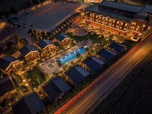 A hotel with multiple buildings, a swimming pool, and a sports field. - ISSA Resort (Turda)