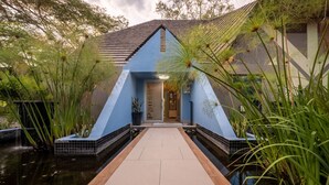 A modern building with a blue facade and a central entrance. - First Group Sanbonani Resort (Mbombela)