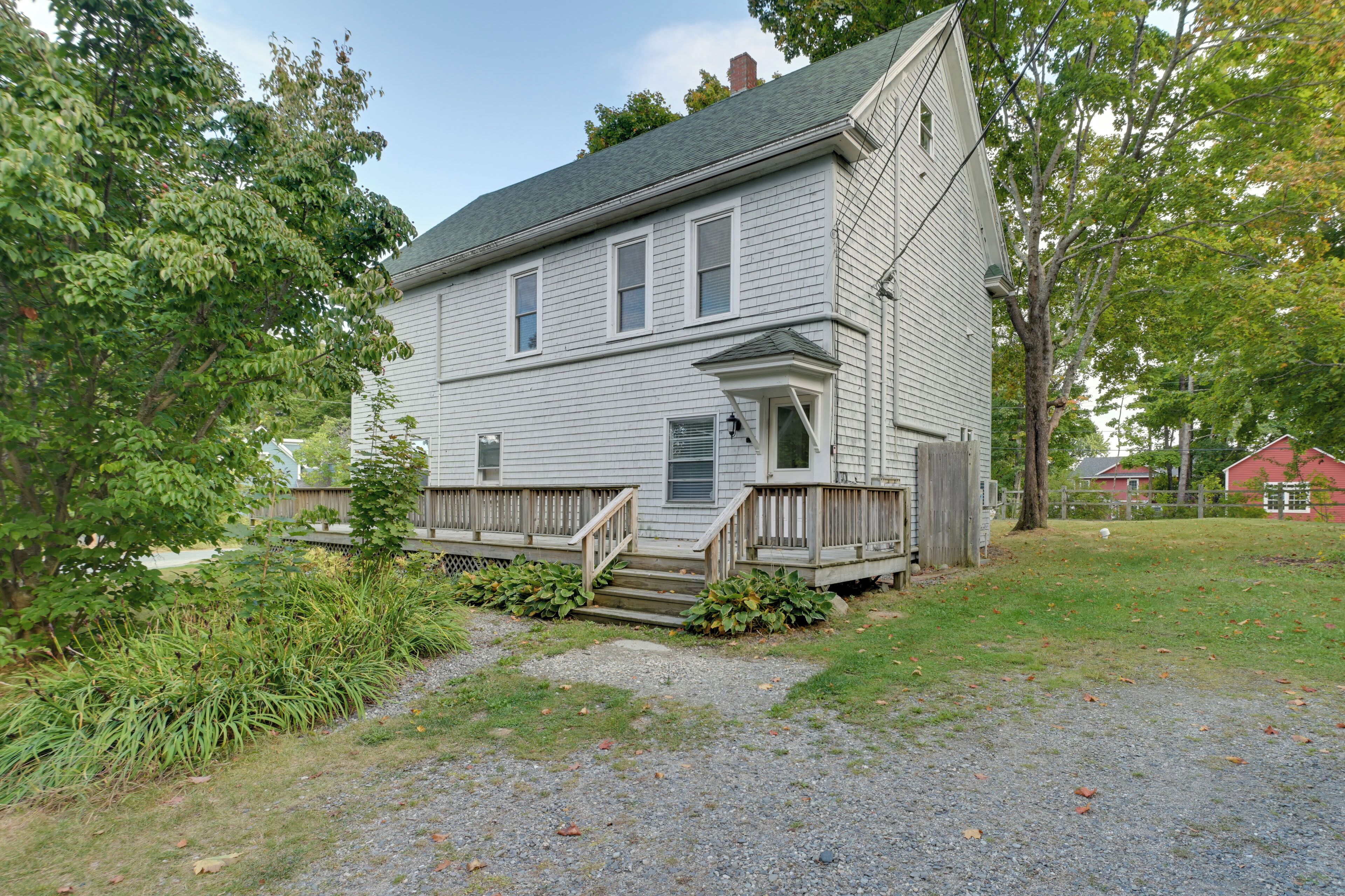 A two-story house with a front porch and a small front yard.