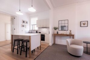 Enjoy meals at the central island or dining table in this well-equipped kitchen.