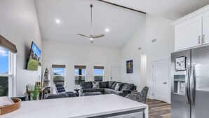 A spacious kitchen with a large island, modern appliances, and a contemporary design. - Nautical Nest (Rockport)