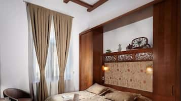 Ein Schlafzimmer mit Bett, Stuhl, Schreibtisch und Kleiderschrank.