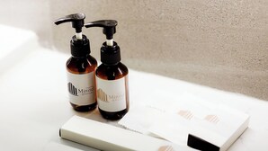 Two bottles of Minitel shower gel and a white box on a white surface. - Minitel at hatyai (Hat Yai)