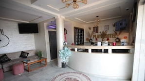 A modern living room with a sofa, coffee table, and a decorative rug. - HOTEL PLAYA DAKHLA (Dakhla)