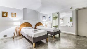 A modern hotel room with two beds, a large mirror, and a walk-in closet. - Elegant Loft in the Heart of Milan – Spacious and Stylish
 (Milano)